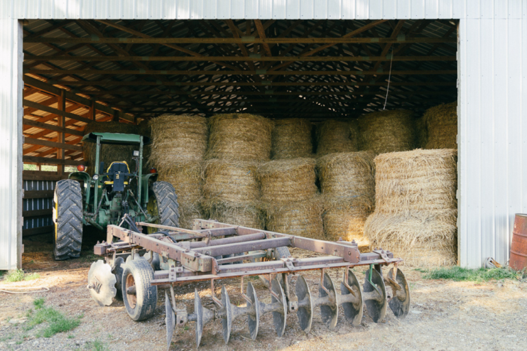 hay and tractor in a barn